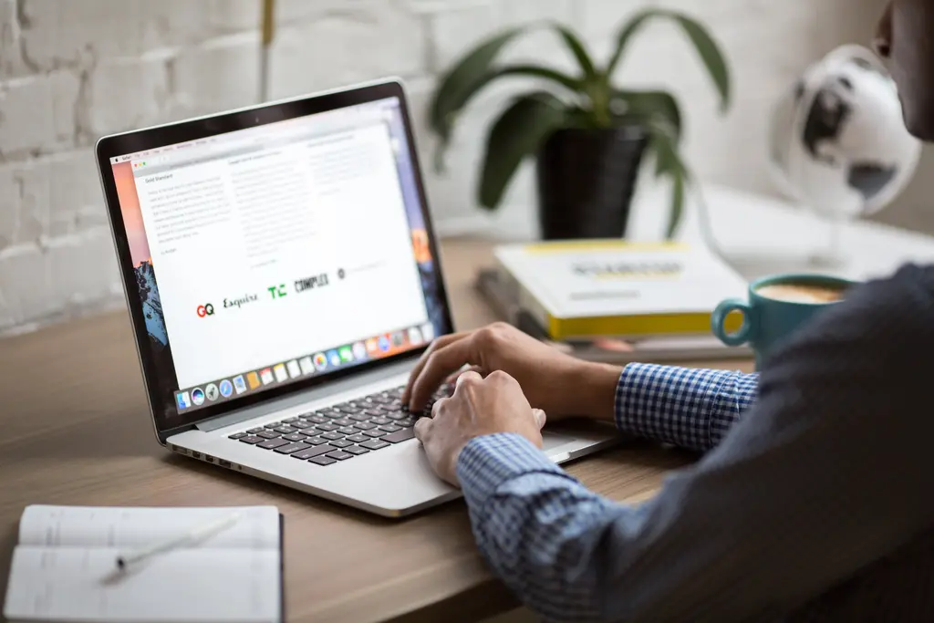 person sitting and working at laptop