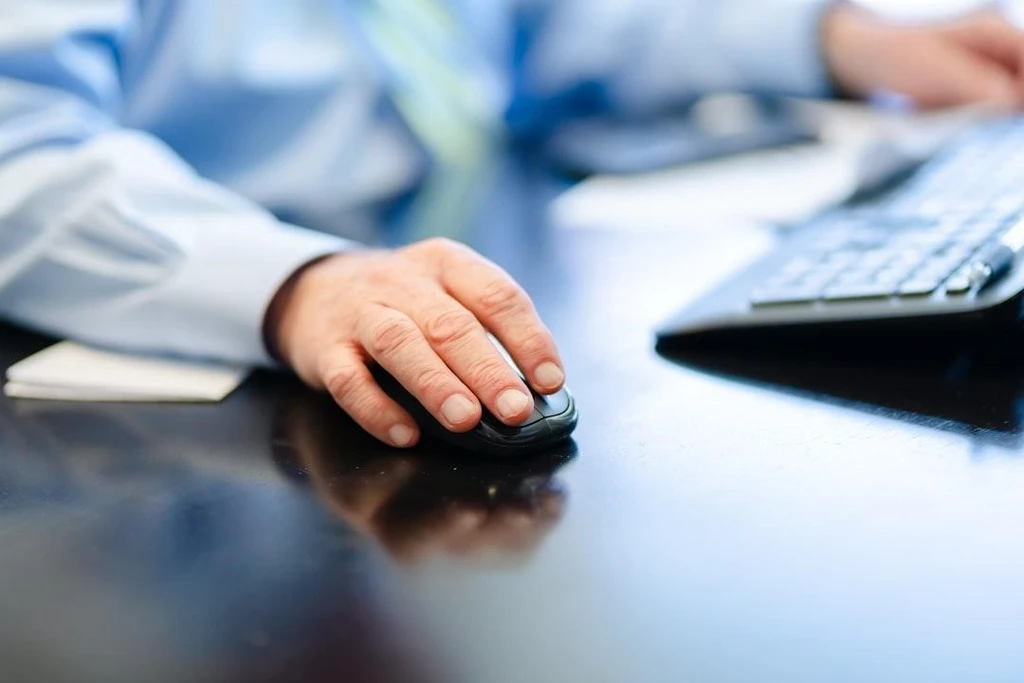 A man holding a wireless mouse