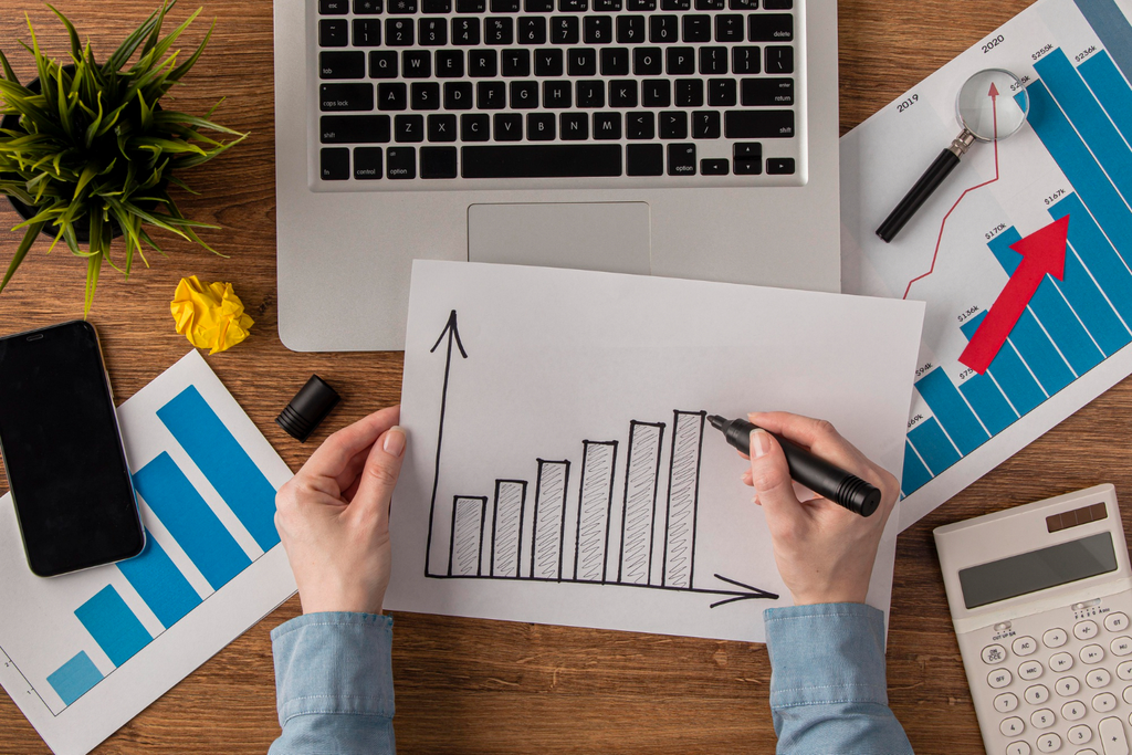 Person looking at positive growth graphs.
