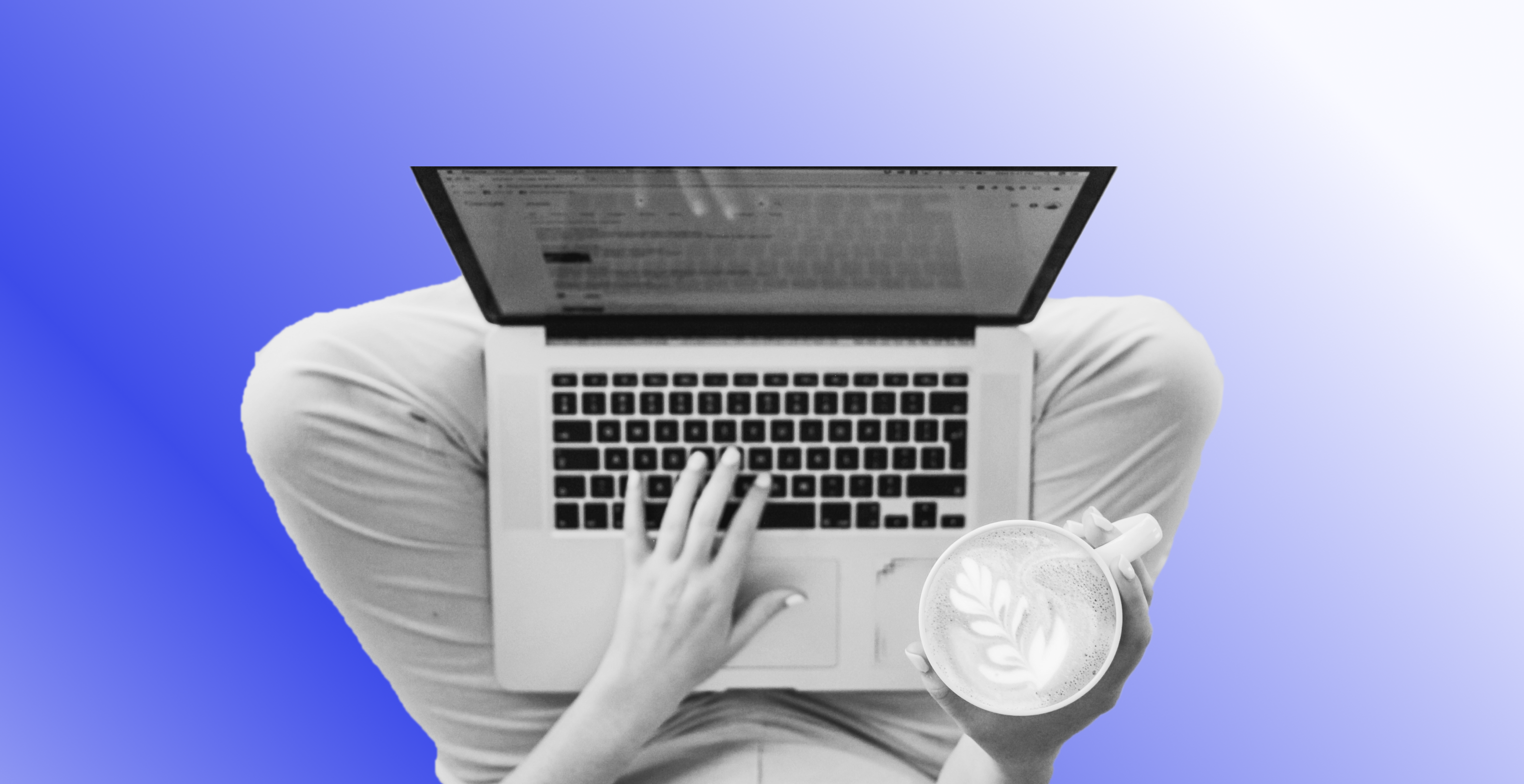 Woman working on her laptop while holding her coffee.