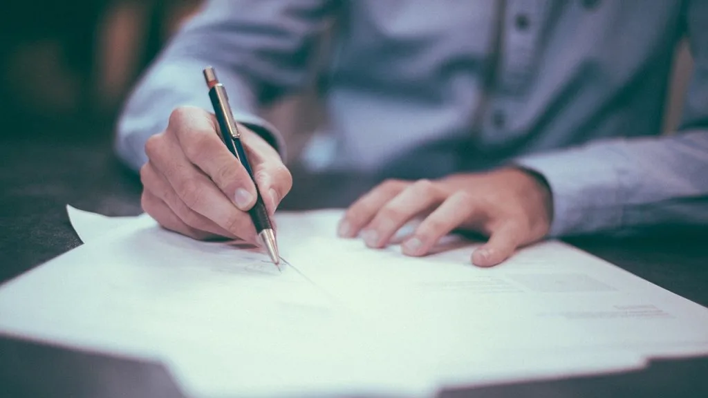 An image of an accountant signing documents