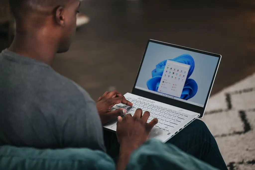 A man typing on his laptop