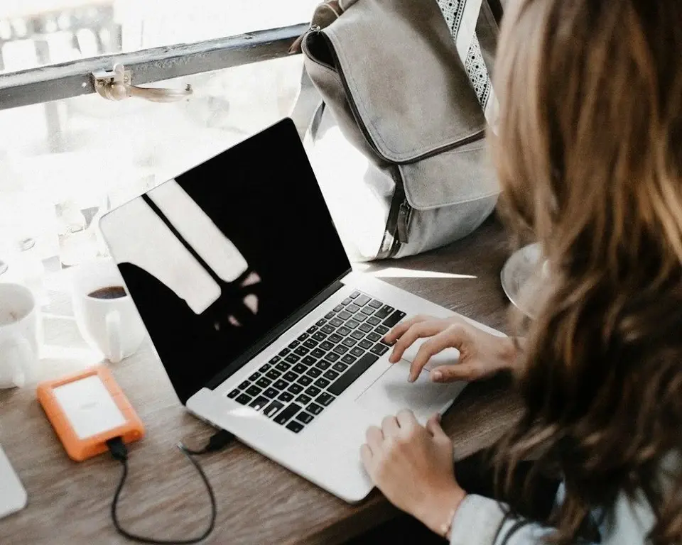A woman using her laptop while charging