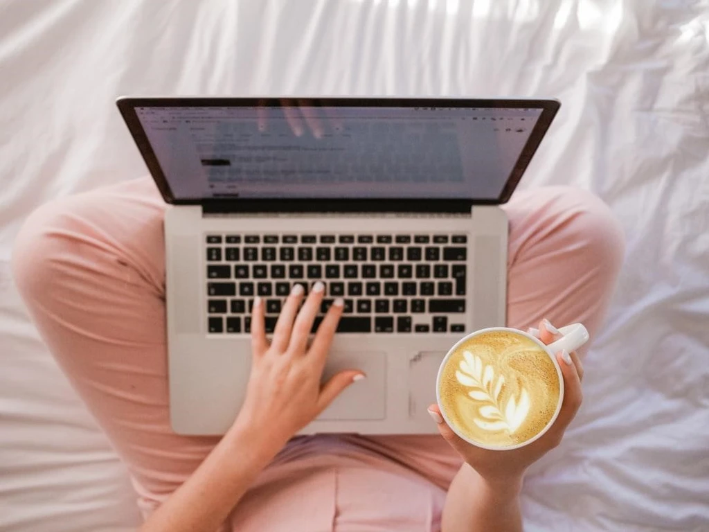 Working using a laptop with a cup of coffee