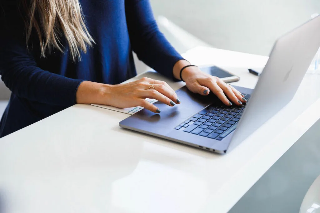 Woman working on laptop.