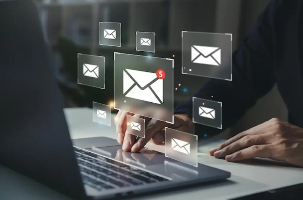 Businessman using laptop with email notification alert on virtual screen