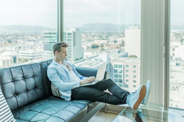 A man using his laptop to send emails